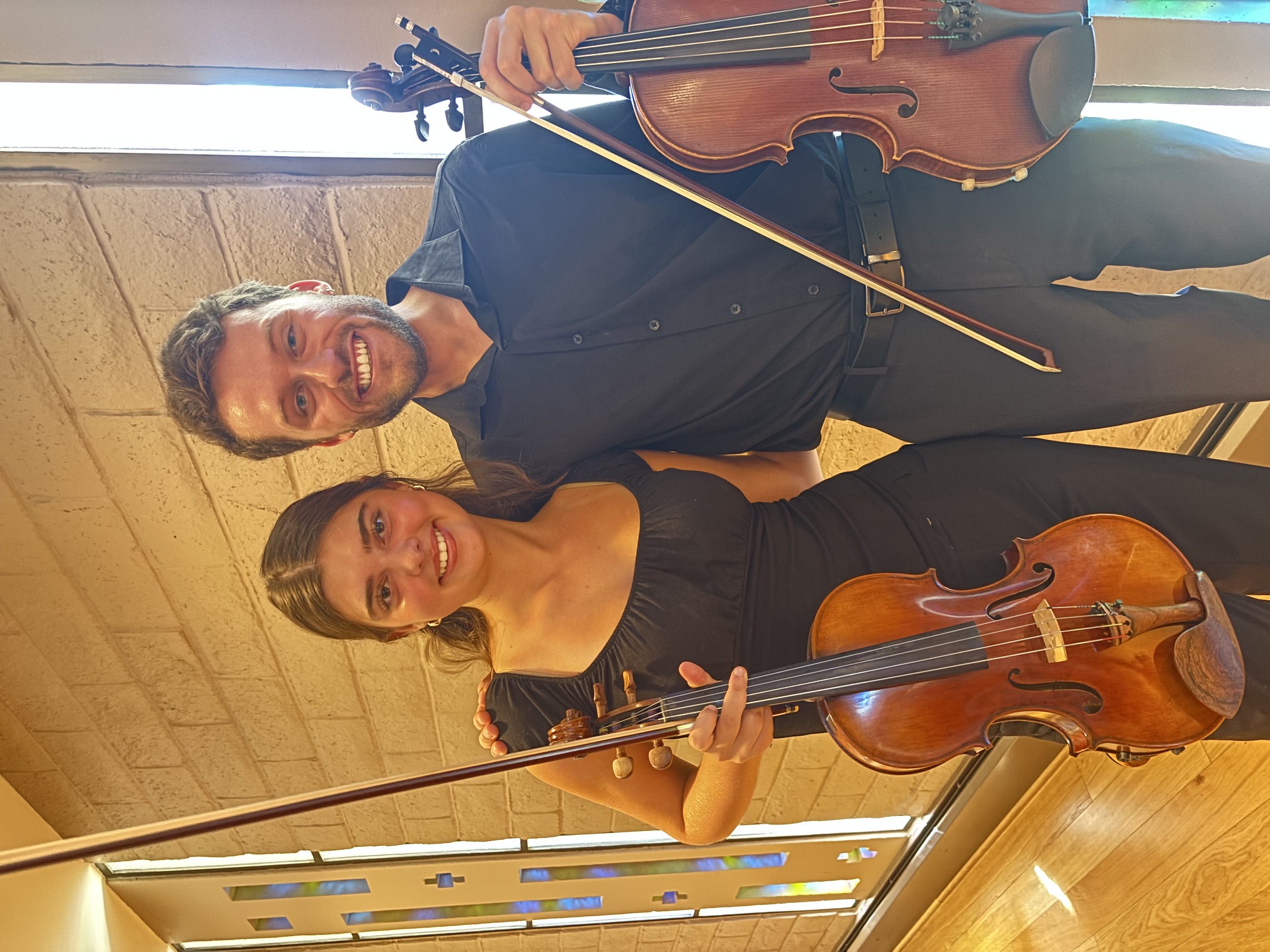 Cam Audras and viola student Ella holding their instruments together